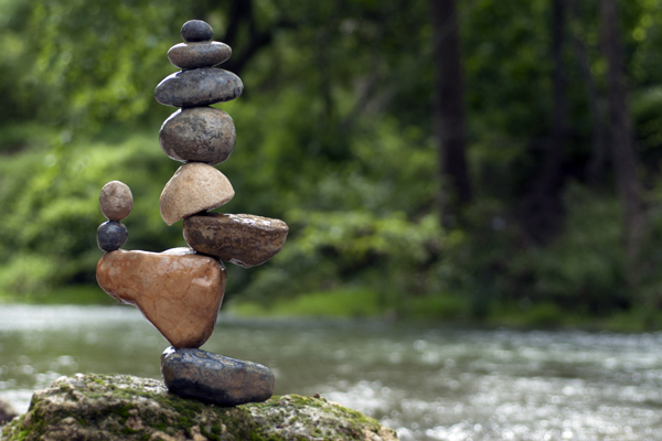 A meticulously balanced cairn of stones by a river